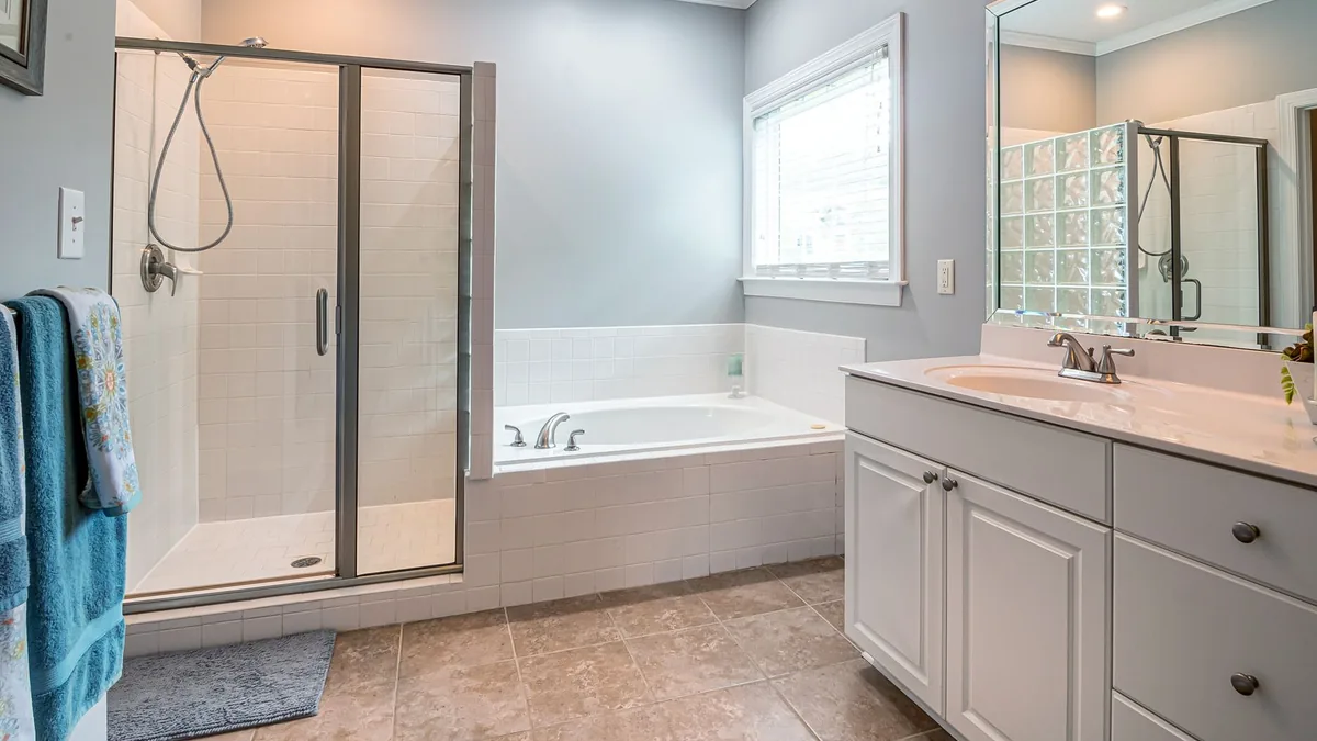 Old bathtub removed to make room for a walk-in shower in St. Paul, MN
